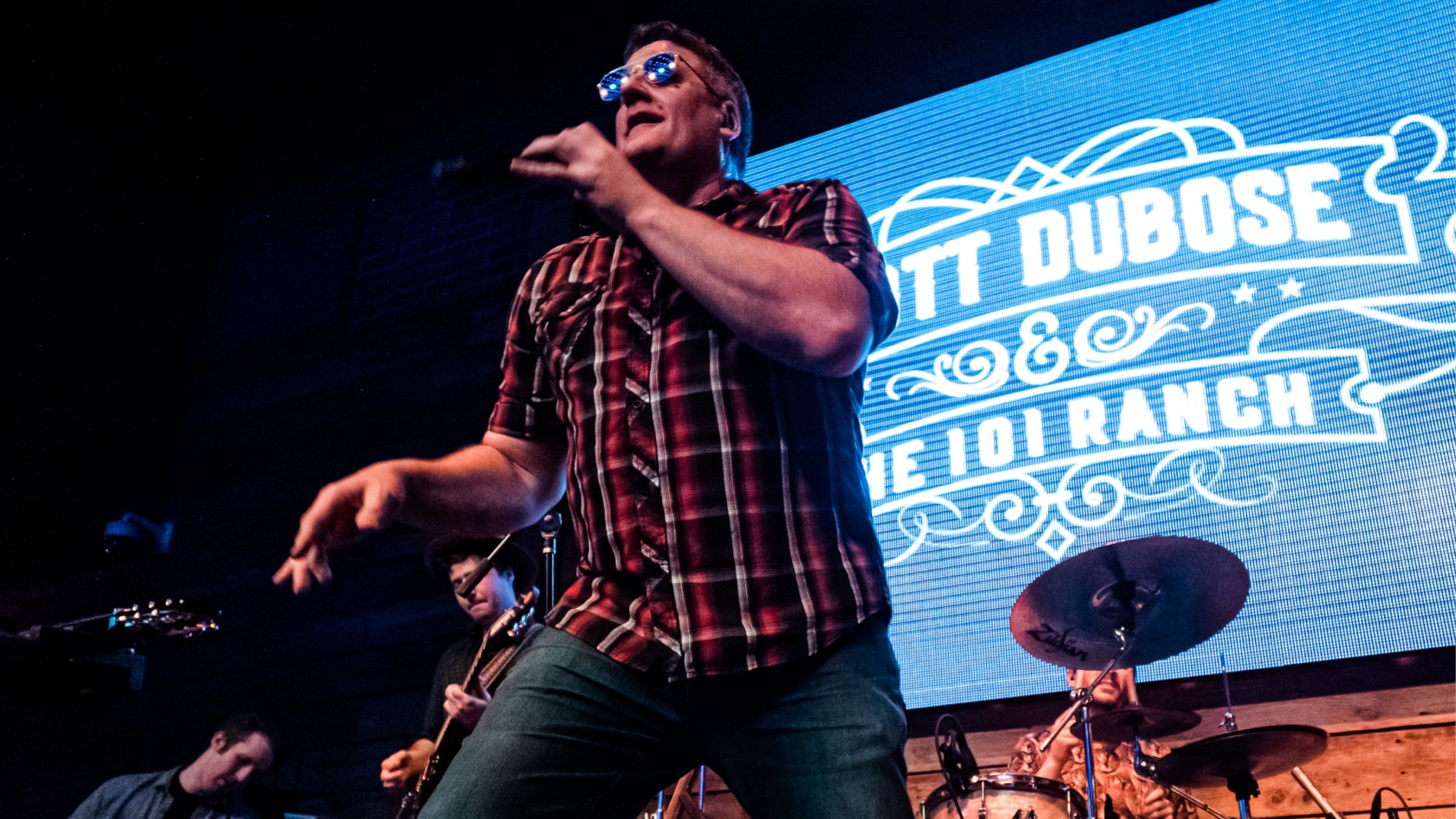 Scott DuBose singing on stage with his band